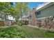 Backyard features a lush lawn, spacious deck, and privacy fence that creates a perfect outdoor oasis at 8150 W Calhoun Dr, Littleton, CO 80123