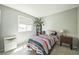 Comfortable bedroom featuring a striped bedspread, a window with natural light, and a side table at 8150 W Calhoun Dr, Littleton, CO 80123