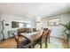 Dining room with a dark wood table, seating for six, and a view into the living room at 8150 W Calhoun Dr, Littleton, CO 80123