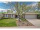 Charming brick home featuring a manicured lawn and beautiful landscaping at 8150 W Calhoun Dr, Littleton, CO 80123