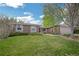 A well-maintained lawn and mature landscaping enhance this charming home's curb appeal at 8150 W Calhoun Dr, Littleton, CO 80123