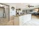 Open kitchen featuring an island, granite countertops, and seamless flow to other rooms at 8150 W Calhoun Dr, Littleton, CO 80123