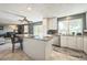 Modern kitchen with granite countertops, stainless steel appliances, and island seating at 8150 W Calhoun Dr, Littleton, CO 80123