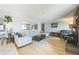 Spacious living room with hardwood floors, fireplace, and comfortable seating area at 8150 W Calhoun Dr, Littleton, CO 80123