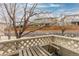 Inviting balcony area features a wooden bench and views of a landscaped common area at 326 W Jamison Pl # 51, Littleton, CO 80120