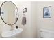 This is a bathroom featuring modern sink, black framed mirror, and neutral wall decor at 326 W Jamison Pl # 51, Littleton, CO 80120