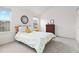 Bedroom showcasing a bed with patterned bedding, natural light, and a dresser at 326 W Jamison Pl # 51, Littleton, CO 80120