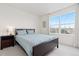 Cozy bedroom with natural light, light blue bedding, and dark wood furniture at 326 W Jamison Pl # 51, Littleton, CO 80120