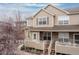 Charming multi-level home with a stone and siding facade, landscaped front yard, and inviting front porch at 326 W Jamison Pl # 51, Littleton, CO 80120