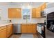 Charming kitchen with oak cabinets, stainless steel appliances, and lots of natural light at 326 W Jamison Pl # 51, Littleton, CO 80120