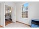 Bright office space with wood floors, large window, and a view into a cozy living room at 326 W Jamison Pl # 51, Littleton, CO 80120