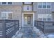 Modern townhome entry with gray door and sleek, minimalist design at 2571 W 69Th Pl, Denver, CO 80221