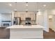 Modern kitchen with white quartz island, stainless steel appliances, and light cabinets at 2571 W 69Th Pl, Denver, CO 80221