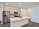 Modern kitchen with stainless steel appliances and a large kitchen island at 2571 W 69Th Pl, Denver, CO 80221