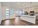 Open concept kitchen and living area with modern fixtures and hardwood floors at 2571 W 69Th Pl, Denver, CO 80221