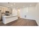 Modern kitchen with white quartz island and stainless steel appliances at 2571 W 69Th Pl, Denver, CO 80221