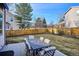 Spacious backyard featuring a well-maintained lawn, a patio, and a dining table with comfortable seating at 10293 Rustic Redwood Ct, Highlands Ranch, CO 80126