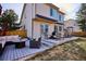 A backyard view featuring a patio with outdoor furniture, grill, and green grass at 10293 Rustic Redwood Ct, Highlands Ranch, CO 80126