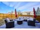 Inviting backyard patio features a cozy seating area with plush cushions and a fire pit for outdoor enjoyment at 10293 Rustic Redwood Ct, Highlands Ranch, CO 80126