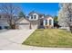Charming two-story home featuring a manicured lawn and a three car garage at 10293 Rustic Redwood Ct, Highlands Ranch, CO 80126