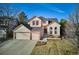 Charming two-story home with a three-car garage and well-manicured lawn at 10293 Rustic Redwood Ct, Highlands Ranch, CO 80126