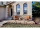 Inviting front porch with comfortable seating and stone accents, perfect for relaxing outdoors at 10293 Rustic Redwood Ct, Highlands Ranch, CO 80126