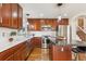The kitchen features stainless steel appliances, stone countertops, and wood cabinetry at 10293 Rustic Redwood Ct, Highlands Ranch, CO 80126