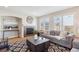 Bright living room features fireplace with decorative tile and large windows with shutters at 10293 Rustic Redwood Ct, Highlands Ranch, CO 80126