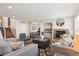 Bright living room features a fireplace, modern furnishings, and hardwood floors at 10293 Rustic Redwood Ct, Highlands Ranch, CO 80126
