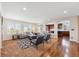 Spacious living room with hardwood floors, modern furnishings, and seamless flow to the kitchen at 10293 Rustic Redwood Ct, Highlands Ranch, CO 80126