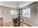 Charming dining area with a round table and four green velvet chairs at 9410 Nagel, Thornton, CO 80229