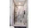 Modern shower with elegant tile and pebble floor at 9410 Nagel, Thornton, CO 80229