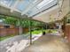Covered back patio with ceiling fans and a view of the landscaped backyard and mature trees at 6550 E 6Th Avenue Pkwy, Denver, CO 80220
