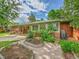 Charming backyard with brick home, patio, garden beds, and mature landscaping provides a peaceful outdoor space at 6550 E 6Th Avenue Pkwy, Denver, CO 80220
