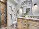 Bathroom featuring a double vanity, tiled shower, and contemporary fixtures at 6550 E 6Th Avenue Pkwy, Denver, CO 80220