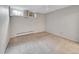Bright bedroom boasts two windows with a neutral decor, radiator, and carpet flooring at 6550 E 6Th Avenue Pkwy, Denver, CO 80220