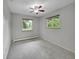 Bright bedroom features a ceiling fan, neutral tones, and natural light from two windows at 6550 E 6Th Avenue Pkwy, Denver, CO 80220