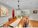 Open concept dining room with chandelier and hardwood flooring at 6550 E 6Th Avenue Pkwy, Denver, CO 80220