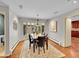 Elegant dining room with a large window, hardwood floors, and sophisticated chandelier at 6550 E 6Th Avenue Pkwy, Denver, CO 80220
