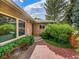Close-up view of brick home's entrance with lush landscaping and brick walkway at 6550 E 6Th Avenue Pkwy, Denver, CO 80220