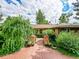 Inviting brick walkway leads to the front door, framed by lush landscaping at 6550 E 6Th Avenue Pkwy, Denver, CO 80220