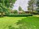 Well-manicured lawn and privacy hedge enhance this inviting, single-story home at 6550 E 6Th Avenue Pkwy, Denver, CO 80220