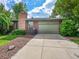 Front exterior of house, featuring garage, chimney, and landscaped entry at 6550 E 6Th Avenue Pkwy, Denver, CO 80220