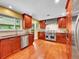 Well-equipped kitchen with stainless steel appliances, granite countertops, and wood cabinetry at 6550 E 6Th Avenue Pkwy, Denver, CO 80220