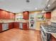 Modern kitchen features stainless steel appliances, stone countertops, and wood cabinets at 6550 E 6Th Avenue Pkwy, Denver, CO 80220