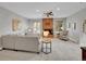 Spacious living room with a brick fireplace, neutral tones, and lots of natural light at 6550 E 6Th Avenue Pkwy, Denver, CO 80220