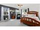 Serene bedroom with ample natural light from large windows and a dark accent wall at 107 Prairie Falcon Pkwy, Brighton, CO 80601
