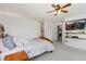 Relaxing bedroom featuring a wall mounted TV and decor shelving at 107 Prairie Falcon Pkwy, Brighton, CO 80601