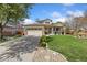 Charming home featuring a well-manicured lawn and a welcoming front porch with great curb appeal at 107 Prairie Falcon Pkwy, Brighton, CO 80601