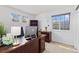 Bright home office with natural light, built-in shelving, and a spacious desk area at 107 Prairie Falcon Pkwy, Brighton, CO 80601